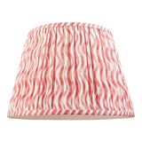 Endon Chartwood 35cm tapered lamp shade in coral pink and white pleated faux linen with a rippled wave print and taped edging, on a white background.