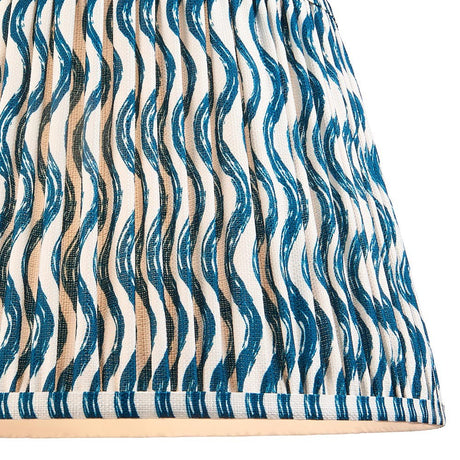 Endon Chartwood 35cm tapered lamp shade in marlin blue, close-up of pleated faux linen with a rippled blue-and-white wave print and taped edge.