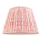Endon Chartwood 40cm tapered lamp shade in coral pink and white pleated faux linen with a rippled wave print and taped edges, on a white background.
