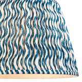 Close-up of the Endon Chartwood 40cm tapered lamp shade in marlin blue, showing pleated faux linen with a wavy ripple print and taped edge.