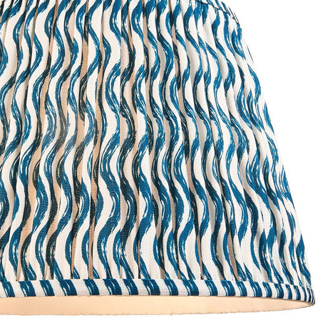 Close-up of the Endon Chartwood 40cm tapered lamp shade in marlin blue, showing pleated faux linen with a wavy ripple print and taped edge.