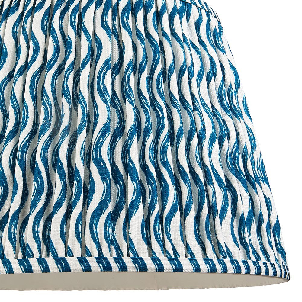 Close-up of Endon Chartwood 40cm tapered lamp shade in marlin blue and white, showing pleated faux linen with a rippled wave print and taped edge.