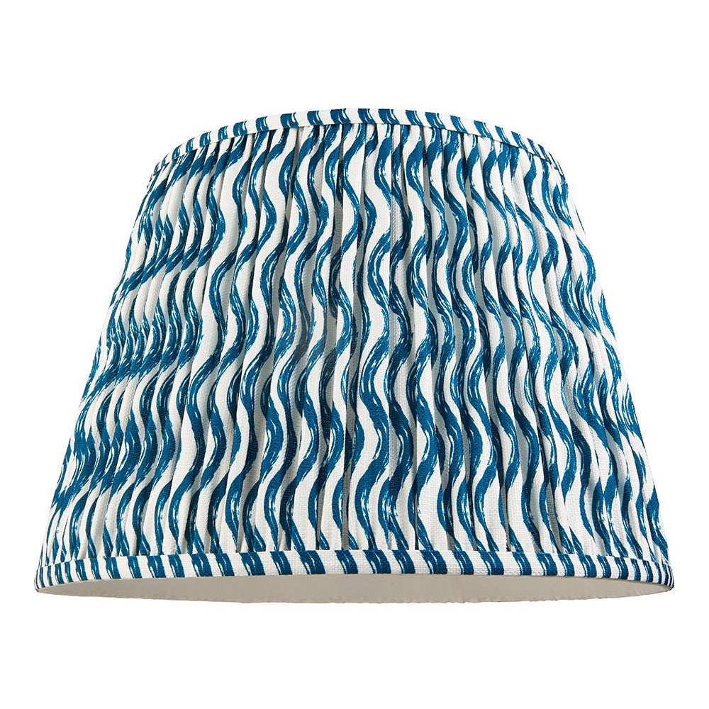 Endon Chartwood 40cm tapered lamp shade in marlin blue and white pleated faux linen with a rippled wave print and taped edging, on a plain background.