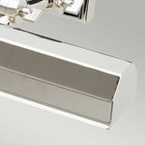 Close-up of a sleek and modern Chawton Medium Picture Light - Polished Nickel with an angular design against a plain gray background. Its adjustable knuckle joints and smooth metallic surface reflect light beautifully, highlighting its polished finish.