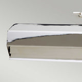 A close-up view of a metallic rectangular object with a shiny, reflective surface, mounted against a light gray background. The object's clean lines and polished nickel finish suggest it could be the Chawton Medium Picture Light - Polished Nickel, complete with adjustable knuckle joints for precise positioning.