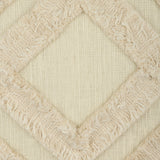 Chevery Cushion in cream cotton, close-up of the textured weave with a tufted, fringed diamond pattern raised across the fabric.