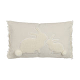 Chevery rectangular cushion in natural and white, featuring two sherpa-fleece rabbits nose to nose with pompom tails and fringed edges, on a plain white background.