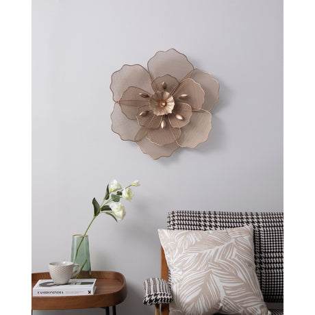 Chikuma Metal Wall Decoration, a large layered flower-shaped wall sculpture in metallic steel with mesh petals and a fluted centre, shown mounted above a sofa and side table in a living room.