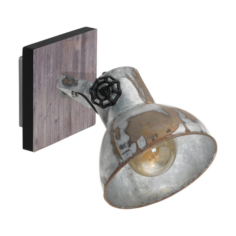 Cimorne wall spotlight with a brown-patina black-edged wood backplate, metal arm with a black valve-wheel knob, and a distressed zinc bell-shaped steel shade for an E27 bulb.