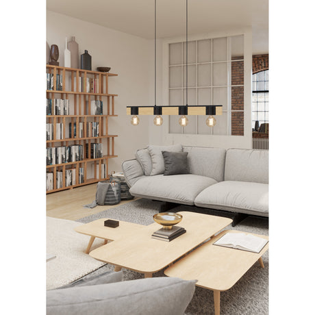 Cirbette linear pendant light with black steel frame and brown wood beam, four E27 bulbs, hung above a sofa in a neutral living room.