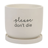White round ceramic plant pot with matching saucer, matt finish, featuring "please don't die" text in script and lower-case lettering, shown on a plain background.