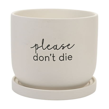 White round ceramic plant pot with matching saucer, matt finish, featuring "please don't die" text in script and lower-case lettering, shown on a plain background.