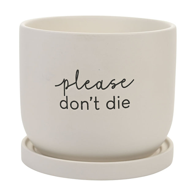 White round ceramic plant pot with matching saucer, matt finish, featuring "please don't die" text in script and lower-case lettering, shown on a plain background.