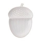 White glazed ceramic serving plate shaped like an acorn, with a pebbled textured cap, ribbed body, and small stem, on a plain white background.