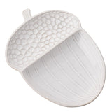 White glazed ceramic serving plate shaped like an acorn, with a pebbled textured cap and ribbed body forming a shallow well, shown on a plain white background.