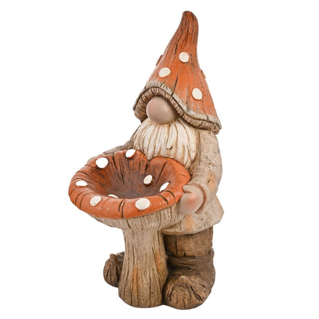 Resin garden ornament bird feeder shaped as a bearded gnome in an orange spotted hat holding a toadstool with a shallow seed dish cap, on a plain white background.