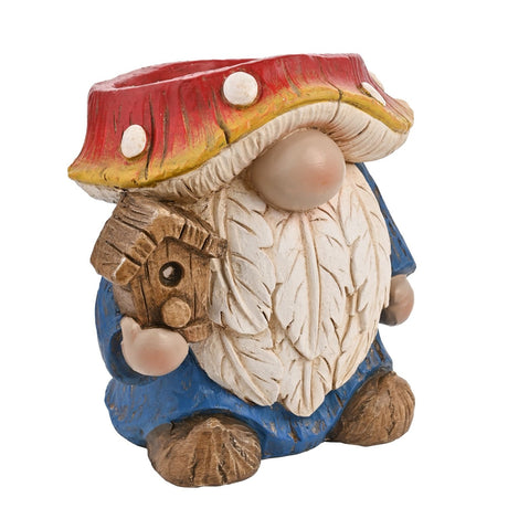 Ceramic gnome planter with a red and white spotted mushroom hat as the pot, cream layered beard, blue robe, brown boots, and a wooden birdhouse held in hand, on a white background.
