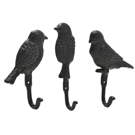 Set of 3 black cast iron wall hooks shaped as birds with detailed feathering, two in profile and one upright, each with a single hook below, on a white background.
