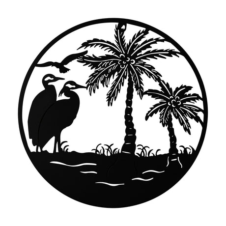Round black metal wall art, 40cm, depicting a silhouette scene of two wading birds by the water, a bird in flight, and two palm trees within a slim circular frame, shown on a plain white background.