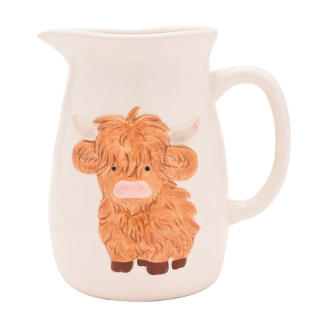 White stoneware jug with a raised highland cow design in ginger-brown, pink nose, pale horns, wide pouring lip and loop handle, on a plain white background.