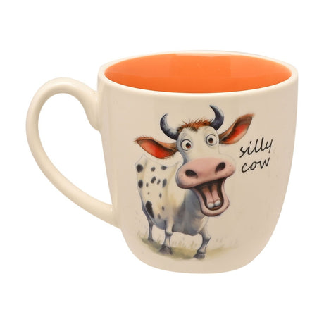 White earthenware mug with orange interior featuring a cartoon cow illustration and "silly cow" text, 300ml capacity, shown on a plain white background.