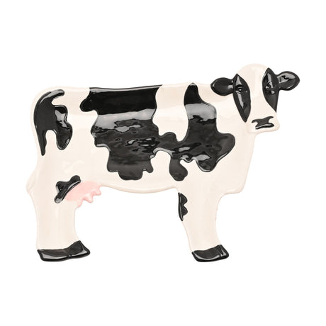 Standing Patch Cow Earthenware Plate, 26.4cm, shaped like a cow with glossy black patches, black ears and hooves, and a pink udder on a white ceramic body, shown on a plain white background.
