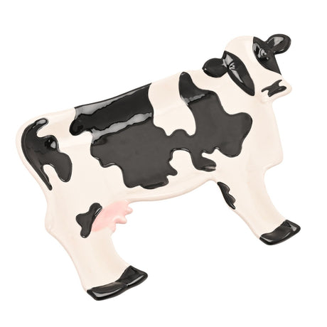 Standing Patch Cow Earthenware Plate, 26.4cm, shaped like a standing cow with glossy black patches, black ears and hooves, and a pink udder on a white ceramic body, shown on a plain background.