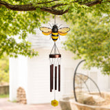 Bee Solar Iron and Glass Wind Chime 92cm in yellow and copper, with a striped bee atop a round cap, four metal tubes and a flower pendant, hanging outdoors from a tree branch.