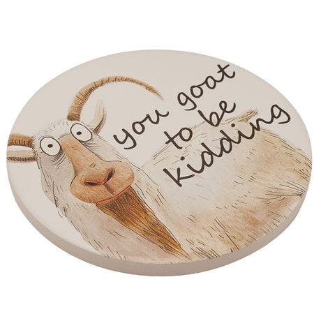 Round ceramic coaster featuring a hand-drawn wide-eyed goat with curly horns and "you goat to be kidding" text, in tan and brown tones on a white background.