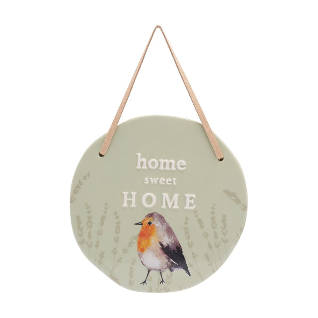 Round ceramic hanging plaque in sage green with "home sweet HOME" lettering, a watercolour robin among lavender sprigs, and a leather hanging strap on a white background.