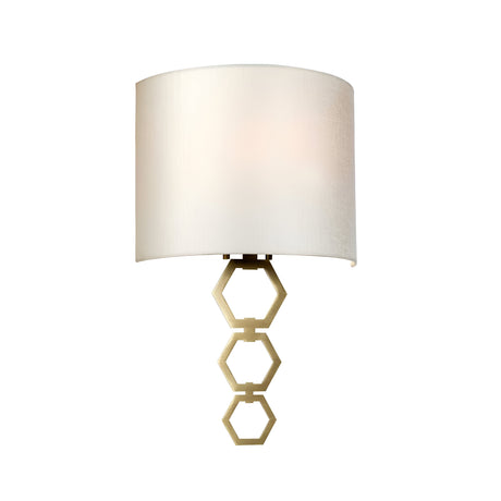 The Clark Medium Wall Light in aged brass features a sleek, modern design with a white faux silk shade. Its base is elegantly adorned with three vertically connected hexagons, offering both ambient lighting and sophisticated style for contemporary interiors.