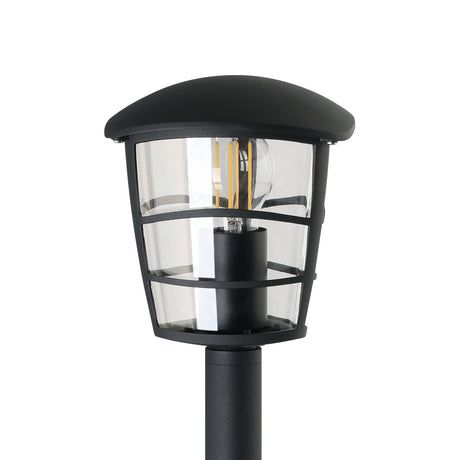 Clasvarne Bollard Light in black, close-up of the lantern-style head with domed cap, slim-barred cage, clear panels and visible E27 bulb atop a slender post, shown on a white background.