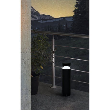 Clerbora LED Bollard Light 45cm in black aluminium with white cone diffuser, shown illuminated on an outdoor balcony beside a railing and potted plant at dusk.