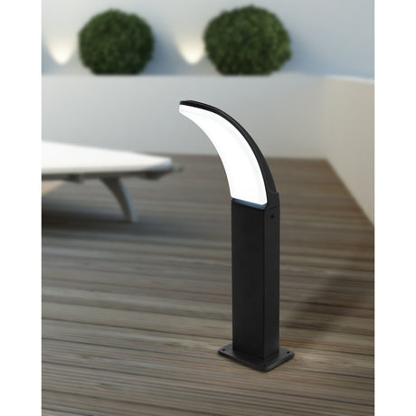 Clesmane 45cm LED bollard light in black aluminium with a curved head and white diffuser, shown illuminated on an outdoor decked terrace.