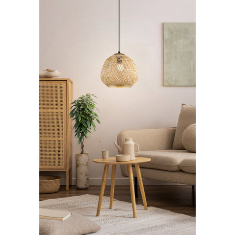 Clivorne wooden pendant light with a round woven natural shade on a black cable and ceiling canopy, hung above a wooden side table in a living room setting.
