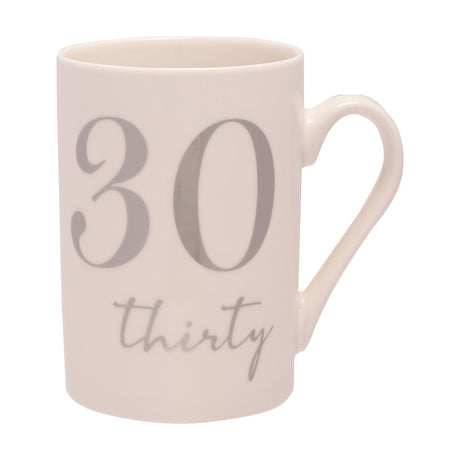 White ceramic 11oz mug with a large silver foil "30" and "thirty" script beneath it, curved open handle, shown on a plain white background.