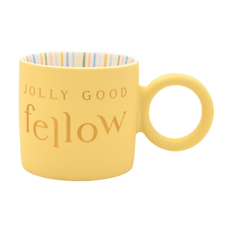 Yellow porcelain mug with round ring handle, matt finish and gold "JOLLY GOOD fellow" text, striped interior, on a plain white background.