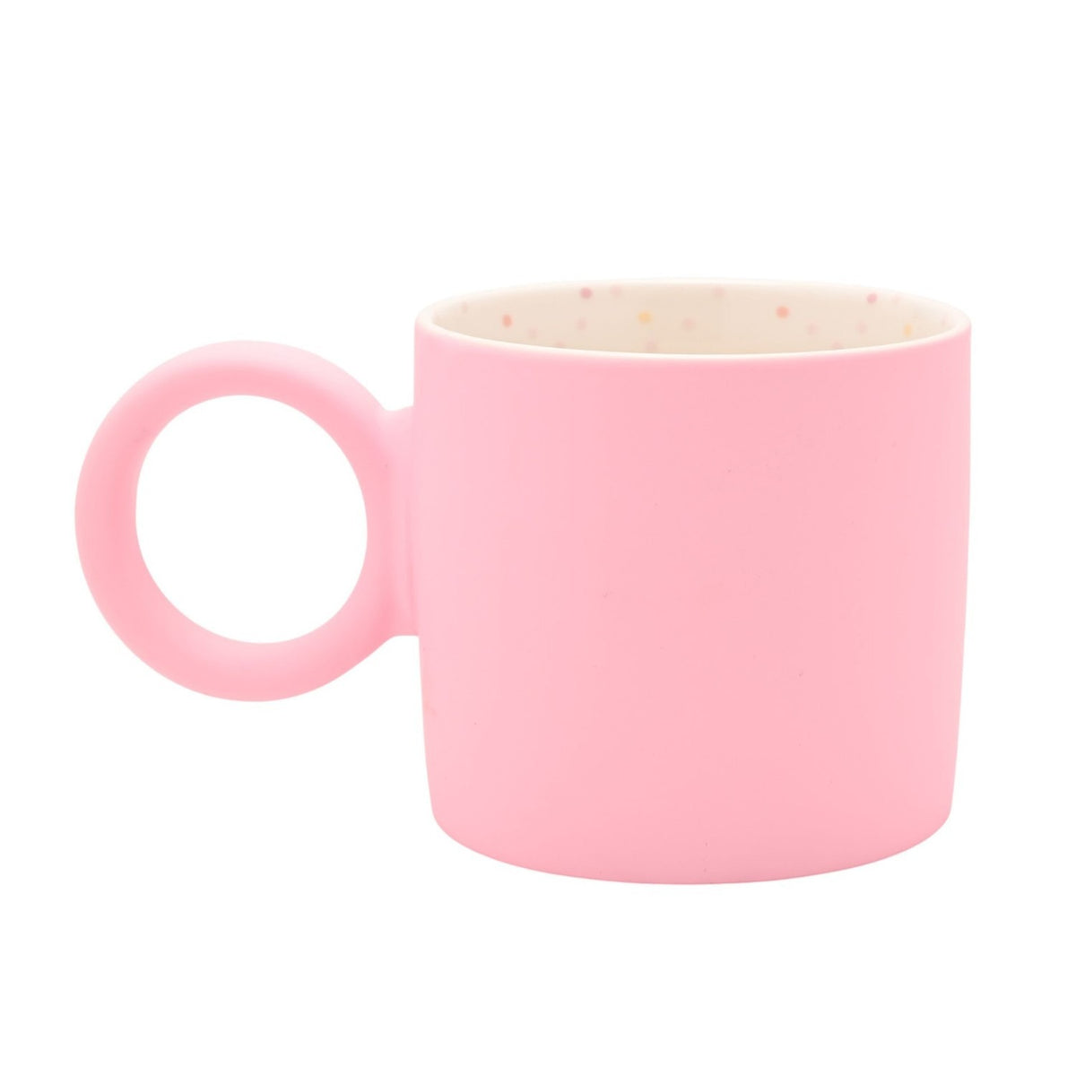 Matt porcelain mug in soft pink with a chunky round ring handle, smooth matt exterior, and a creamy white interior speckled with pink, peach, blue and grey dots, shown on a plain white background.