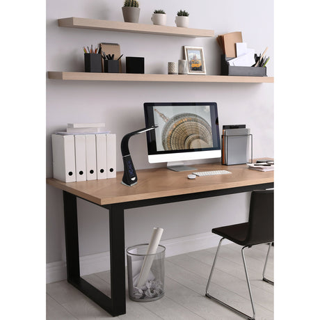 Cognoli LED touch table lamp in black with curved arm and narrow LED panel, shown beside a desktop monitor on a desk in a home office setting.