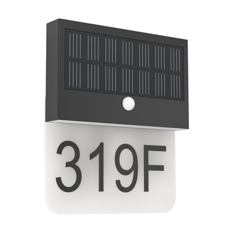 Conettimara solar wall light with motion sensor in black plastic, featuring a slim housing with front solar panel above an illuminated opal panel displaying "319F", shown on a plain white background.