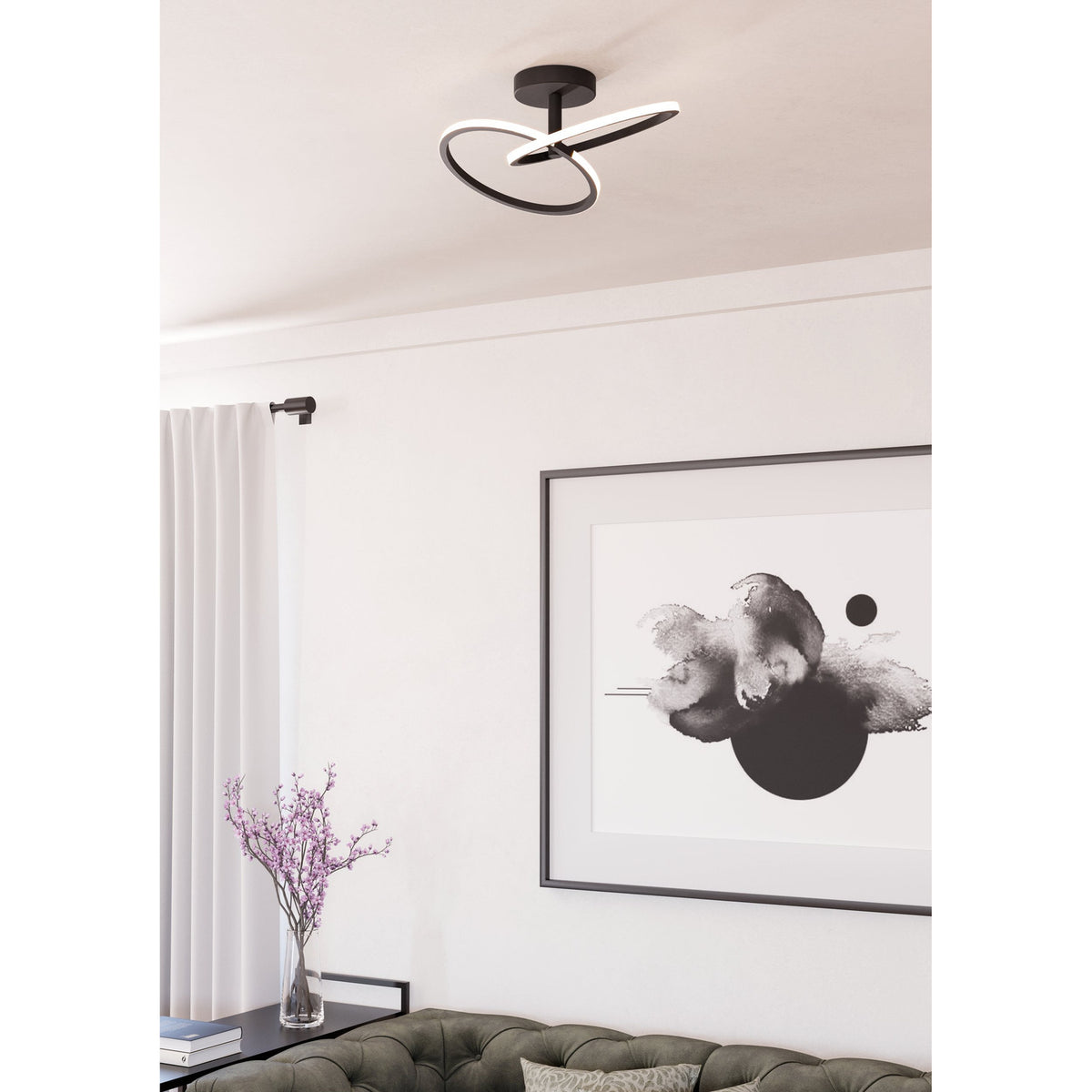 Congiunti LED flush ceiling light in black steel with interlinked rings and white plastic diffusers, mounted on a living room ceiling above a framed abstract print and sofa.