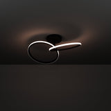 Congiunti LED Flush Ceiling Light in black steel, two interlinked illuminated rings with white diffusers on a round canopy, shown glowing against a dark background.