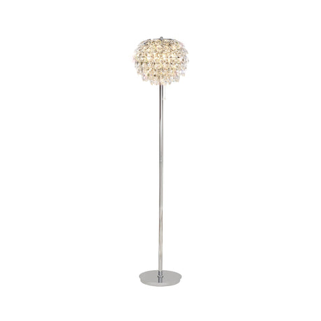 The Coniston 3 Light Crystal Floor Lamp in polished chrome features a tall, slim stand and a round shade with cascading crystal decorations, providing ambient lighting and a warm, soft glow.