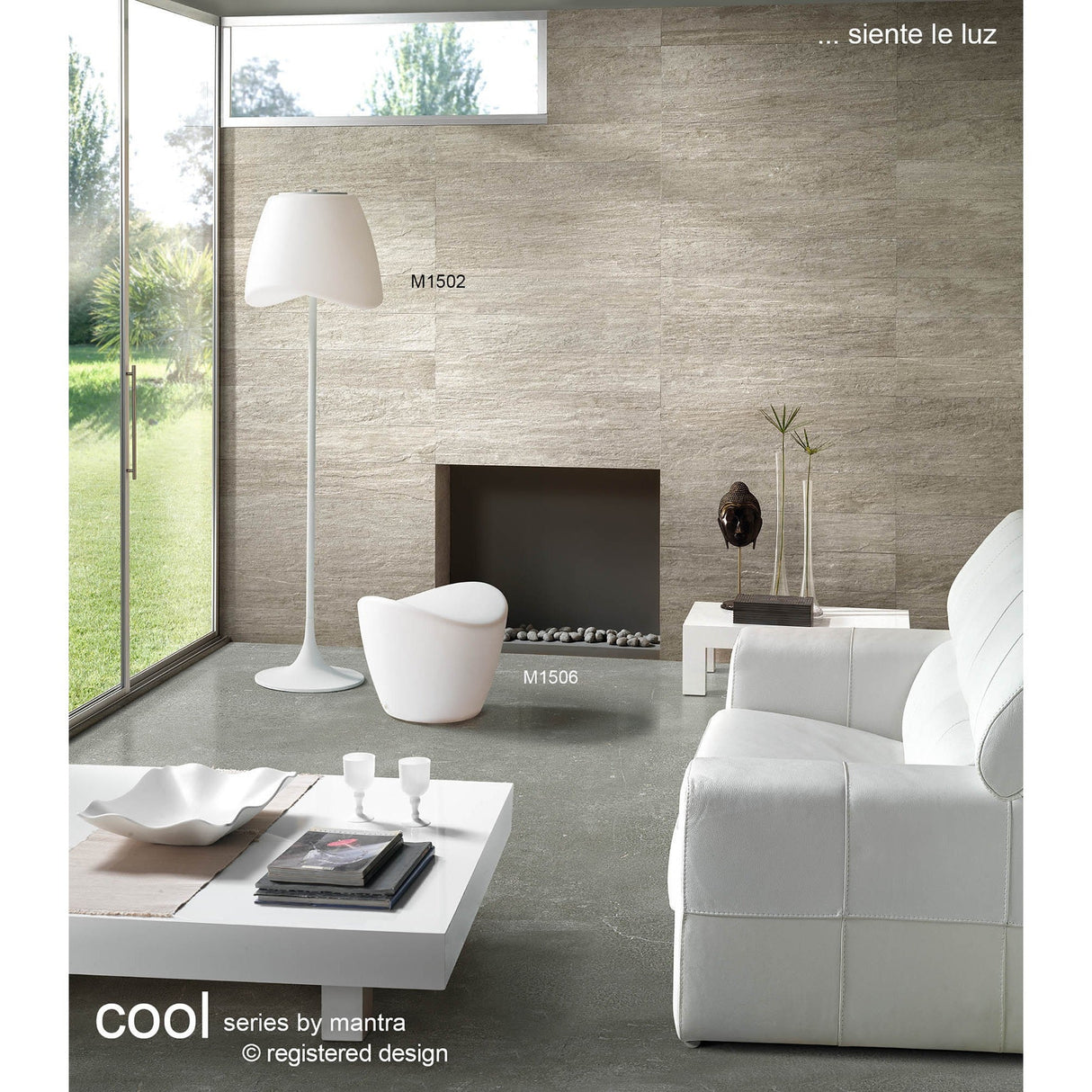 Modern living room featuring a white sofa, coffee table, and the Cool 2 Light Floor Lamp in matt white & opal white for ambient lighting. A unique chair sits by a minimalist fireplace. Large window reveals garden views; neutral tones enhance the calm vibe.