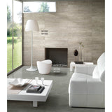 A living room with a fireplace and white couch, accented by the Cool 2 Light Outdoor Floor Lamp in matt white and opal white, bringing a modern touch of garden lighting indoors.