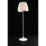 The Cool 2 Light Floor Lamp in matt white with an opal white, asymmetrical shade and slim, straight pole stands against a solid black background, offering stylish dimmable ambient lighting.