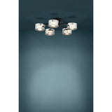 Copillos 5 Light Ceiling Light in black steel with five smoked glass cylindrical shades, mounted close to a dark teal ceiling and glowing warm white when lit.