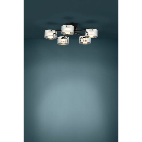 Copillos 5 Light Ceiling Light in black steel with five smoked glass cylindrical shades, mounted close to a dark teal ceiling and glowing warm white when lit.