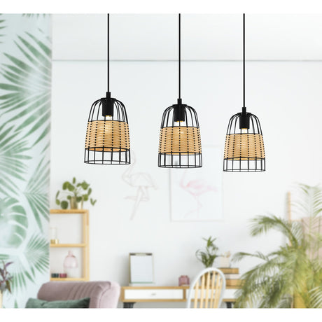 Corbena Rattan Linear Pendant Light in black, three wire cage shades with woven rattan bands on black cords, shown over a dining area with plants and furniture.