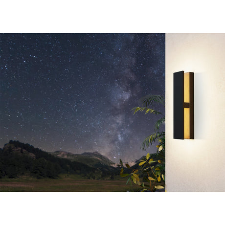Costorio LED Outdoor Wall Light in black and wood-grain brown aluminium, mounted on a light wall, glowing warm white against a night sky backdrop.